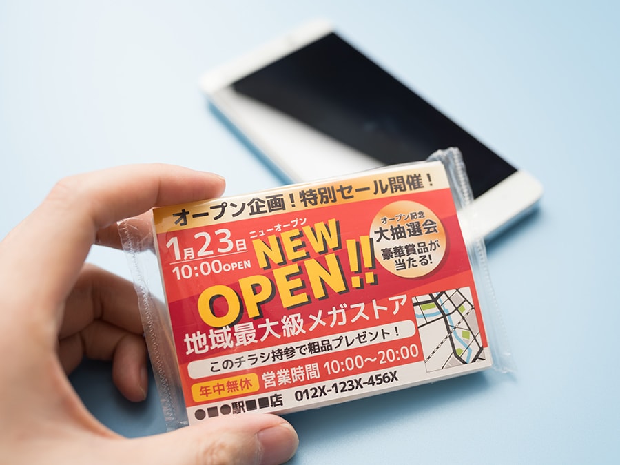 NEW OPENするストアのティッシュとティッシュに入っている広告